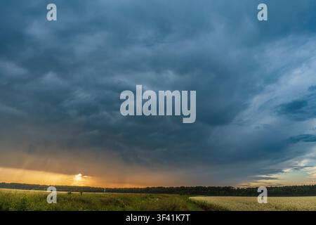 Mammatus Storm Clouds over Countryside at Sunset Stock Photo