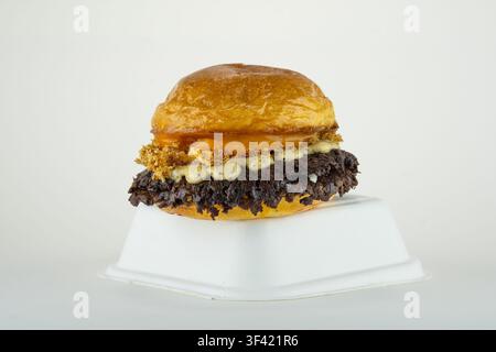 Smash burger showing juicy patty, melted cheese, and special sauce on takeaway box Stock Photo