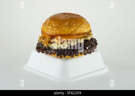 Smash burger with crispy onions and sauce on a takeaway container Stock Photo