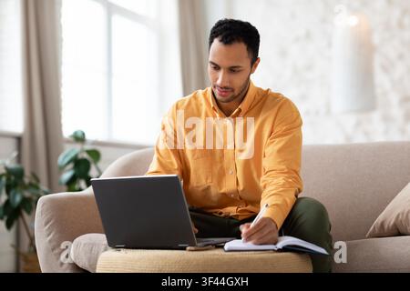 Focused African American Man Working On Laptop At Home, Remote Work Concept Stock Photo