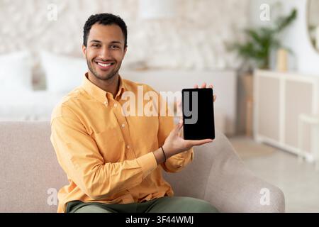 Smiling Young African American Man Holding Tablet At Home, Business Concept Stock Photo