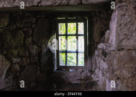 Deeply Recessed Window in Thick Ancient Stone Wall Stock Photo
