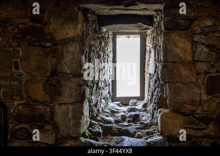 Deeply Recessed Window in Thick Ancient Stone Wall Stock Photo