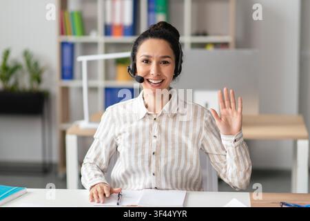 Smiling Hispanic Woman Customer Service Representative With Headset At Office, Business Concept Stock Photo