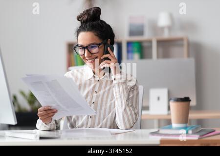 Happy Latin American Woman Working From Home, Making Phone Call, Business Concept Stock Photo