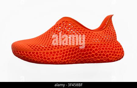Orange 3D printing shoe showcasing innovative design and advanced manufacturing technology Stock Photo