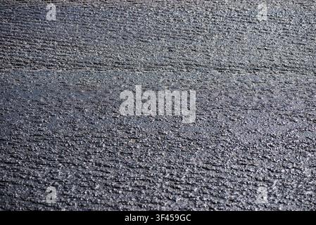Detailed macro photography of rough structured crushed stone pavement surface Stock Photo