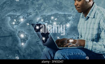 Travel booking process using a laptop with a world map background showing flight routes and locations Stock Photo