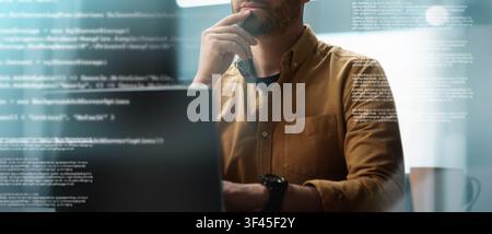 Focused Male Working On Laptop In Office, Business Concept Stock Photo