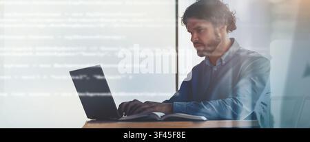 Focused Caucasian Male Developer Coding On Laptop In Modern Office Space, Business Concept Stock Photo