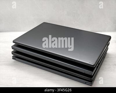 stack of laptops on a gray background, on the table, laptop computer, tablet, business, work, remote work, freelance. Stock Photo