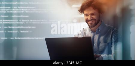 Happy Male Software Developer Working On Laptop In Office, Business Concept Stock Photo