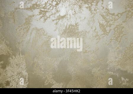 Decorative Venetian plaster texture with metallic gold and pearlescent shine on interior wall surface Stock Photo