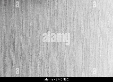 White textured plaster wall with subtle vertical brush-stroke grooves, providing a neutral minimalist background ideal for design, architecture, const Stock Photo