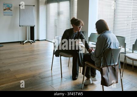 Woman Therapist Counseling Young Woman in Support Group Session Stock Photo