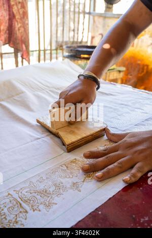 A detailed view of traditional batik textile featuring intricate orange ...