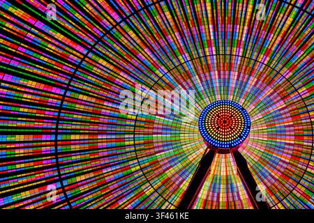 Colourful illuminated ferris wheel at night. Stock Photo