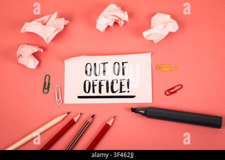 Out of Office text written on paper surrounded by pencils and office supplies Stock Photo