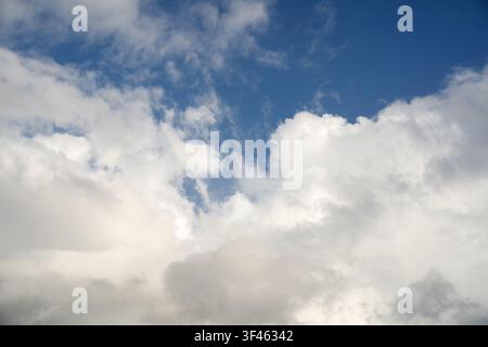Dramatic tropical cloud formation with bright blue sky opening, natural weather background ideal for atmospheric and climate concepts. Stock Photo