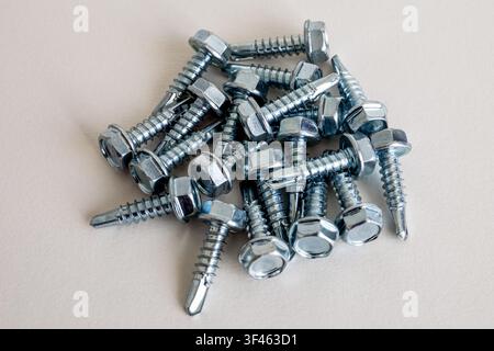 Metal hex head self drilling screws with drill tips for fastening metal surfaces Stock Photo