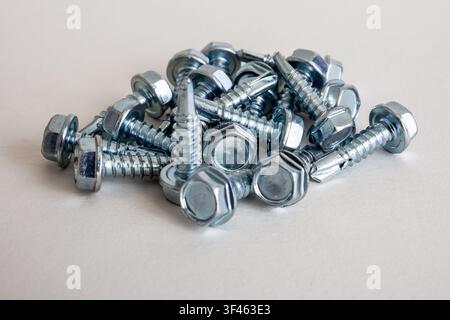 Metal hex head self drilling screws with integrated washers for secure fastening in construction Stock Photo