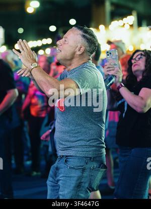 Happy man dancing and clapping at a night party Stock Photo