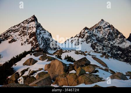 Rugged snow covered mountains, Foley and Welch, at golden hour Stock Photo