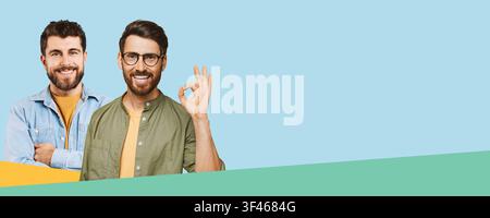 Two Young Men Smiling Together In Casual Attire, One Showing Okay Gesture, Business Concept Stock Photo