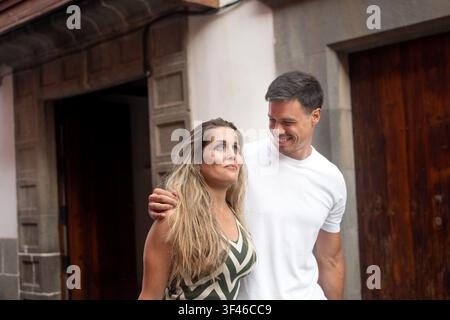 Young couple enjoying a romantic moment while exploring a historic city together. Stock Photo