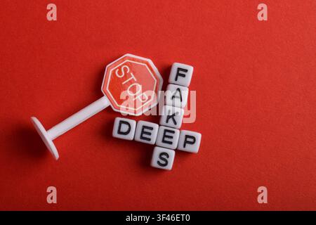 Words fake news formed with letter cubes and a stop sign, representing misinformation warning, media literacy Stock Photo