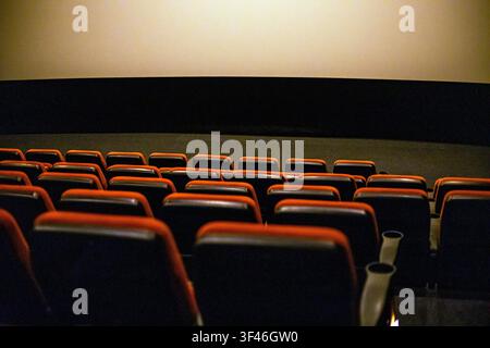 Empty red soft seats in the cinema after watching a film Stock Photo