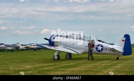Vintage aircraft display at Oostwold Airshow, Canadian Car and Foundry T 6J Harvard Mk. IV airplane on a grassy field in Oostwold, Groningen, Netherla Stock Photo