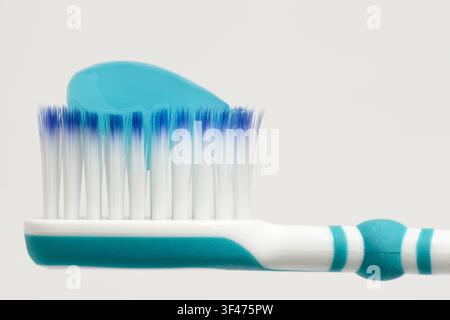 Toothbrush head with blue toothpaste on Stock Photo