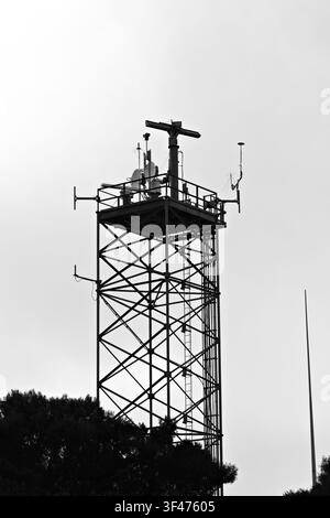Metal communications tower with a muted sky background Stock Photo