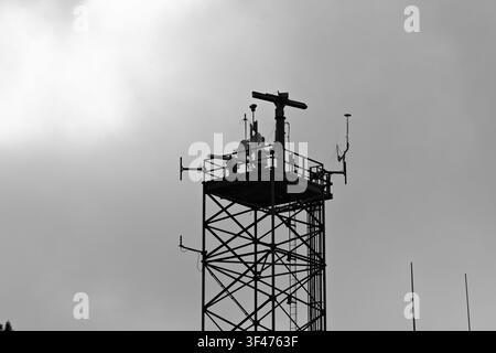 Metal communications tower with a muted sky background Stock Photo