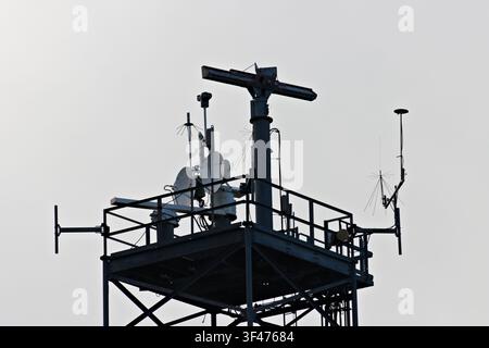 Metal communications tower with a muted sky background Stock Photo