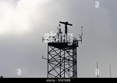 Metal communications tower with a muted sky background Stock Photo