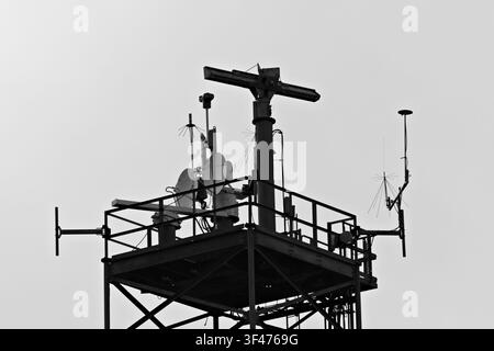 Metal communications tower with a muted sky background Stock Photo