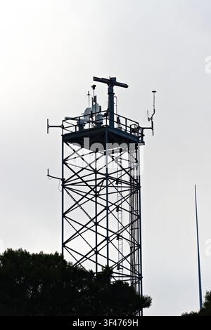 Metal communications tower with a muted sky background Stock Photo