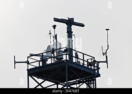 Metal communications tower with a muted sky background Stock Photo