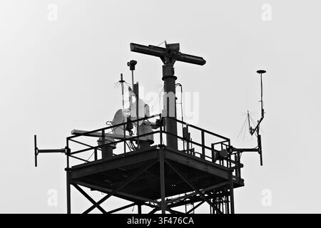 Metal communications tower with a muted sky background Stock Photo