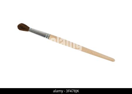 Round artist paintbrush with brown pony hair bristles, unfinished natural wood handle and silver metal ferrule isolated on a white background. Ideal f Stock Photo