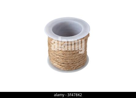 White plastic spool wound with natural jute twine, isolated on a white background. Ideal for packaging, gardening, floristry, crafts and eco-friendly Stock Photo