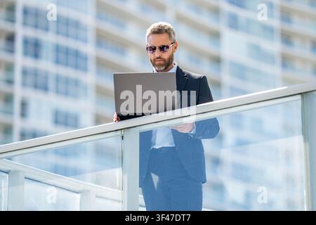 Business man work online. Remote working. Businessman leader work on laptop. Man check business report. Leadership success. Analyzing data Stock Photo