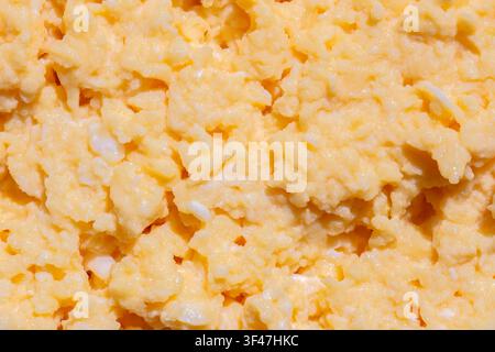 Organic scrambled egg, made with chicken eggs, butter and milk, background backdrop. Healthy breakfast food concept. Stock Photo