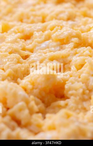 Organic scrambled egg, made with chicken eggs, butter and milk, background backdrop. Healthy breakfast food concept. Stock Photo