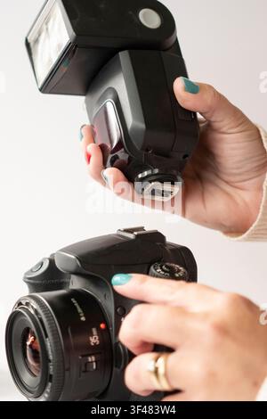 Installing an External Flash onto DSLR Camera; Vertical Image Stock Photo