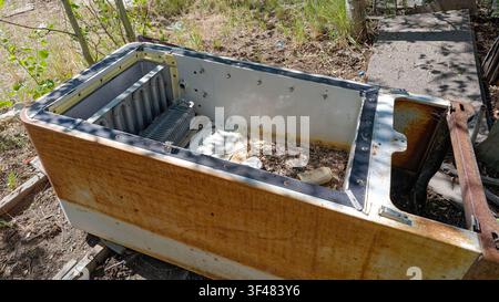 A rusty refrigerator without a door is laying in the yard of an abandoned mining shack in Nevada, USA Stock Photo