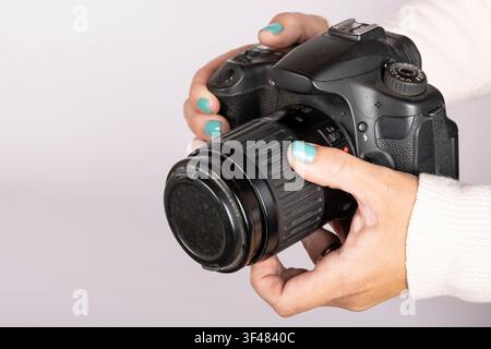 Holding DSLR Camera with Lens Cap Attached Stock Photo