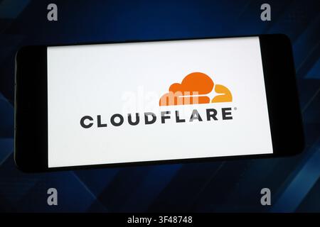 Cloudflare logo displayed on a smartphone screen. Cloudflare is a web infrastructure and cybersecurity company Stock Photo